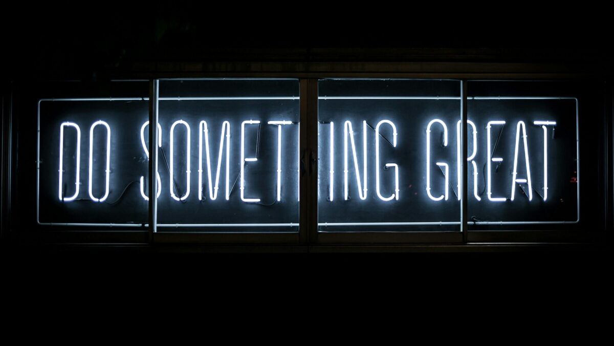 A neon sign that says "Do Something Great"